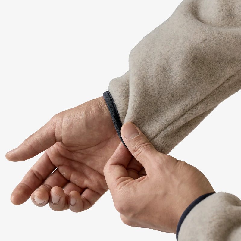Man pulling the sleeve of the Patagonia Men's Lightweight Synchilla Snap-T Fleece Pullover