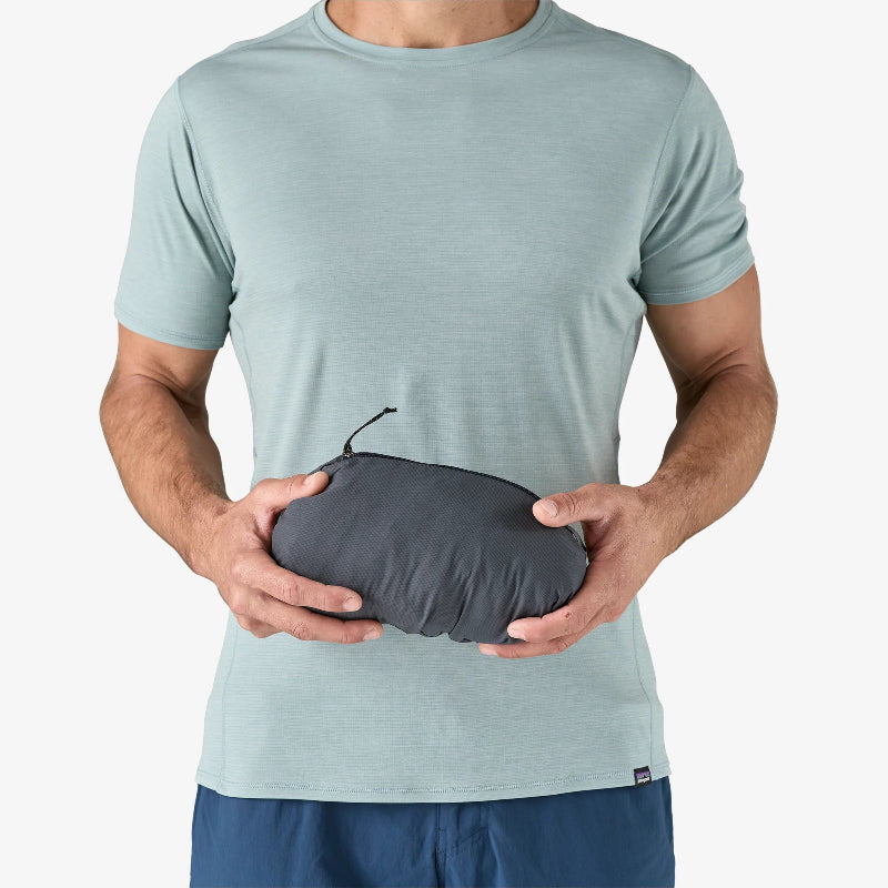 Man holding the Patagonia Men's Nano-Air® Ultralight Full-Zip Hoody packed in its pocket