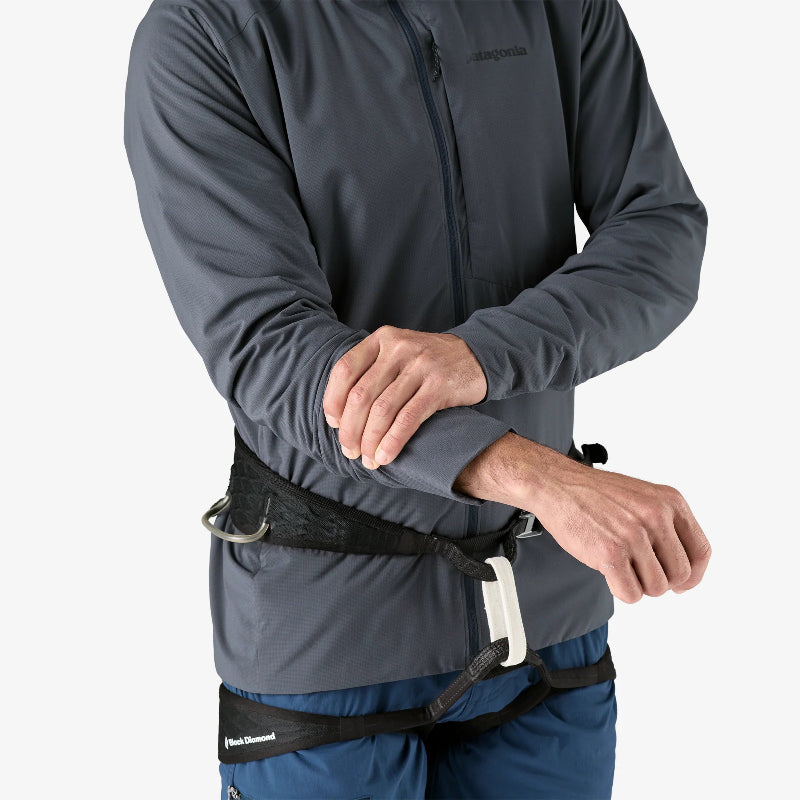 Man wearing the Patagonia Men's Nano-Air® Ultralight Full-Zip Hoody with a climbing harness, pulling up his sleeves