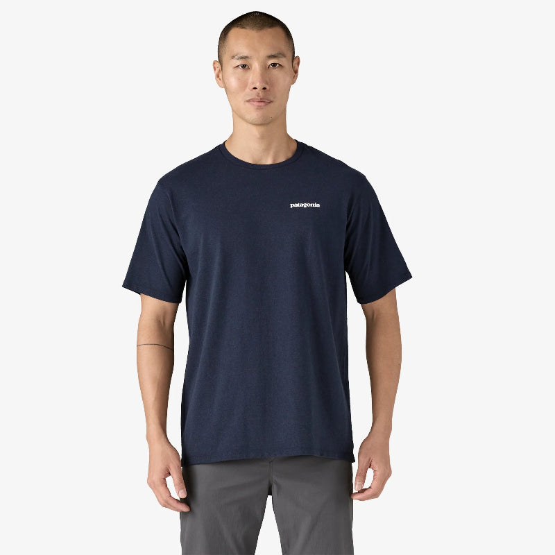 Man wearing the Patagonia Men's P-6 Logo Responsibili-Tee in navy standing front on