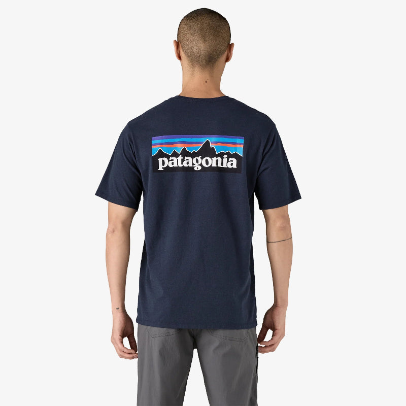 Man wearing the Patagonia Men's P-6 Logo Responsibili-Tee in navy showing the back