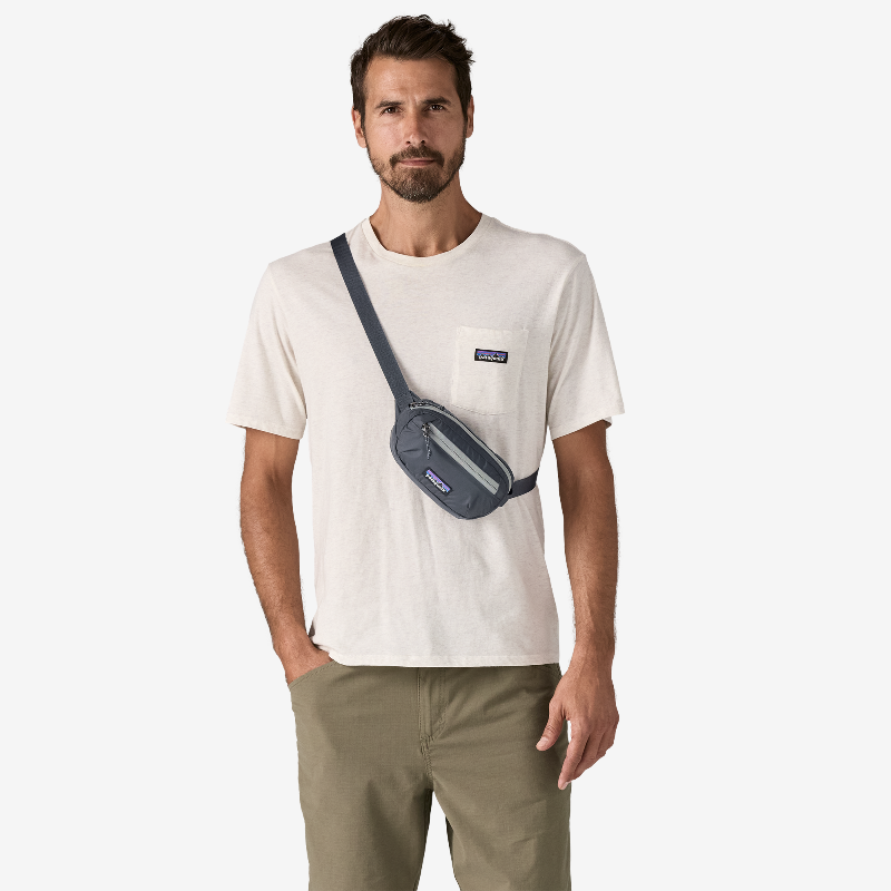 Man wearing a smolder blue Patagonia Terravia Mini Hip Pack 1L as a chest pack