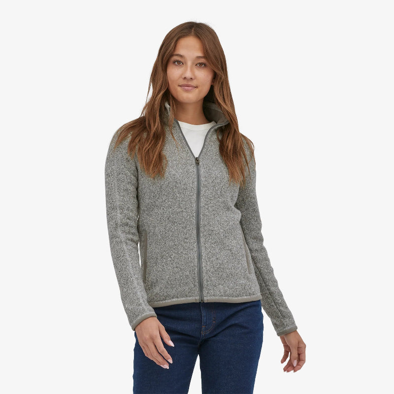 Woman wearing the Patagonia Women's Better Sweater Fleece Jacket in birch white with a white shirt and denim jeans