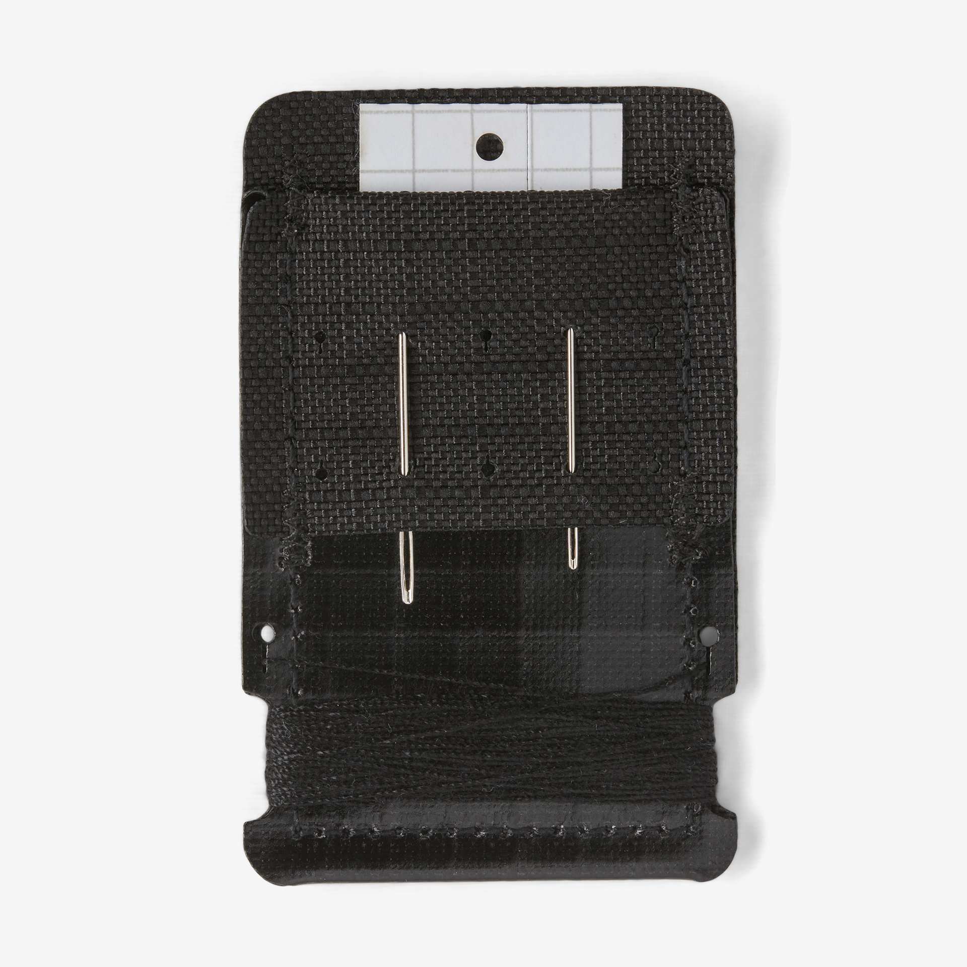 The back of the Patagonia Worn Wear Field Repair Kit with sewing needles