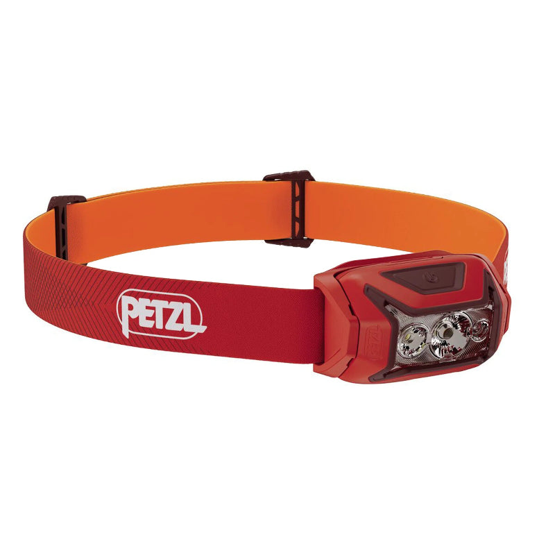 Red headlamp with orange strap on a white background, featuring Petzl logo.