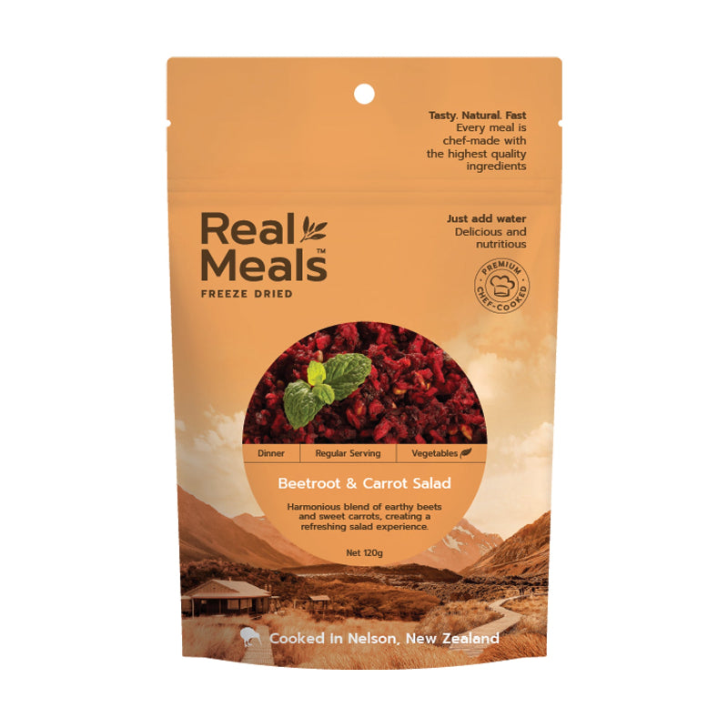 Real Meals freeze-dried beetroot & carrot salad package with mountain and cabin background