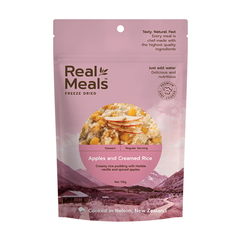 Pink package of Real Meals freeze-dried apples and creamed rice with a scenic background.