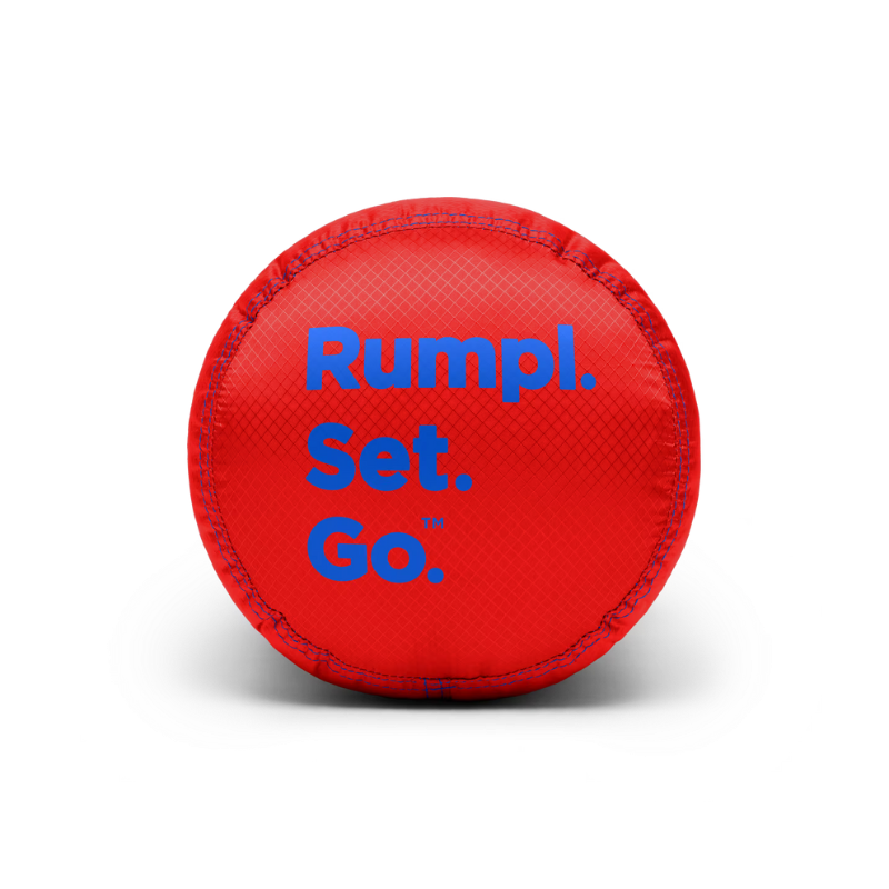A red circular textured ball with blue text reading 'Rumpl. Set. Go.' on a clean white background.