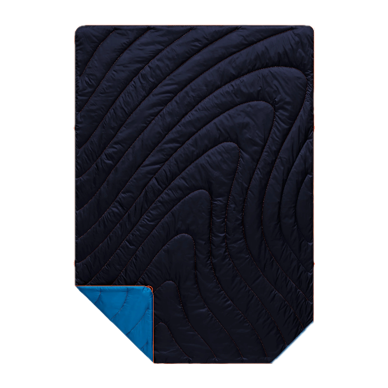 A dark navy quilted sleeping pad with a wavy, flowing pattern of stitching, shown with a corner folded over to reveal a bright blue backing on a solid white background.