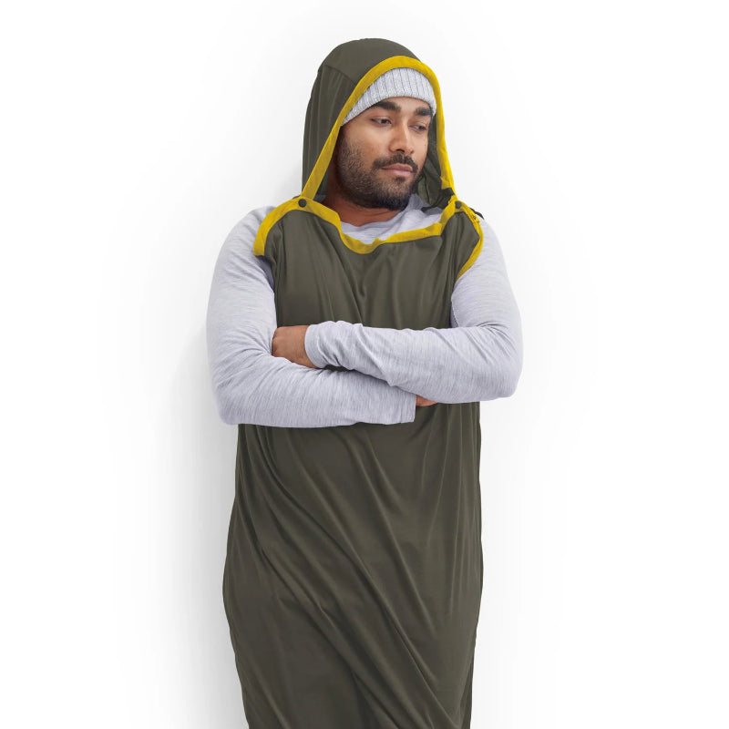 Person wearing a green and yellow hooded garment on a white background