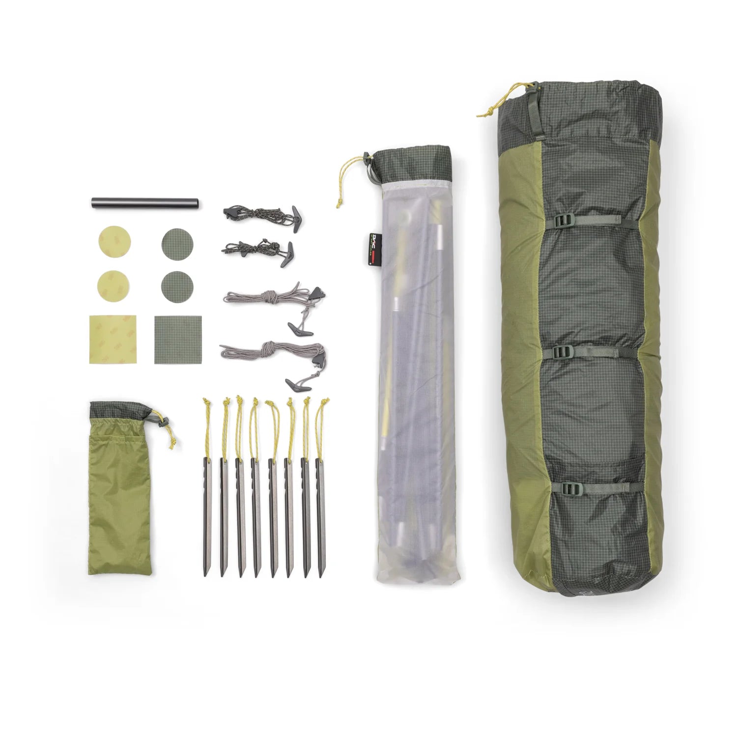 Camping gear set including a sleeping bag, tent stakes, and other accessories on a white background