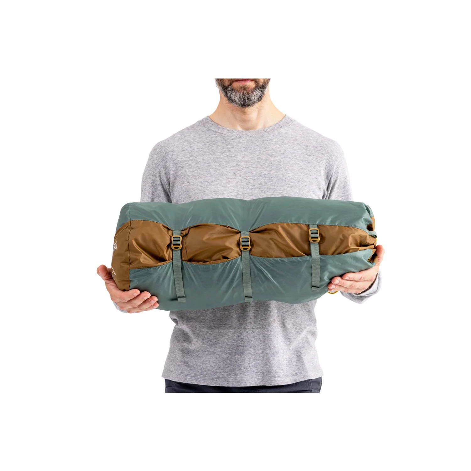 Person holding a green and brown bag against a white background