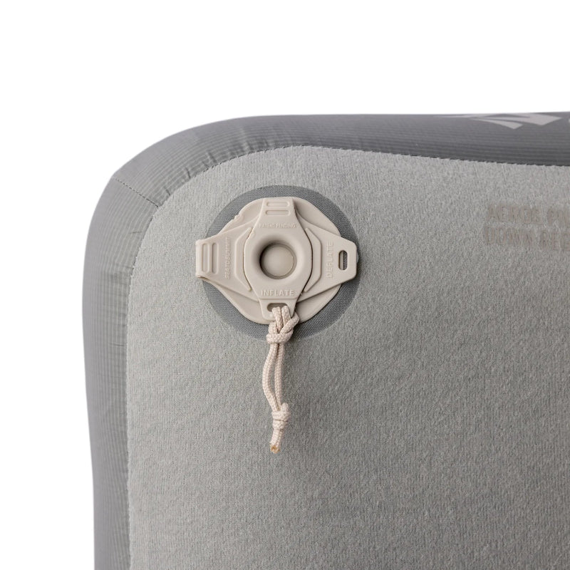 Close-up of a gray inflatable mattress with valve and rope on a white background