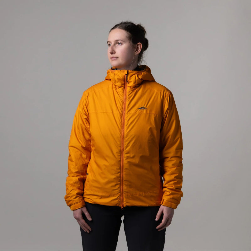 Person wearing a bright orange jacket against a plain background