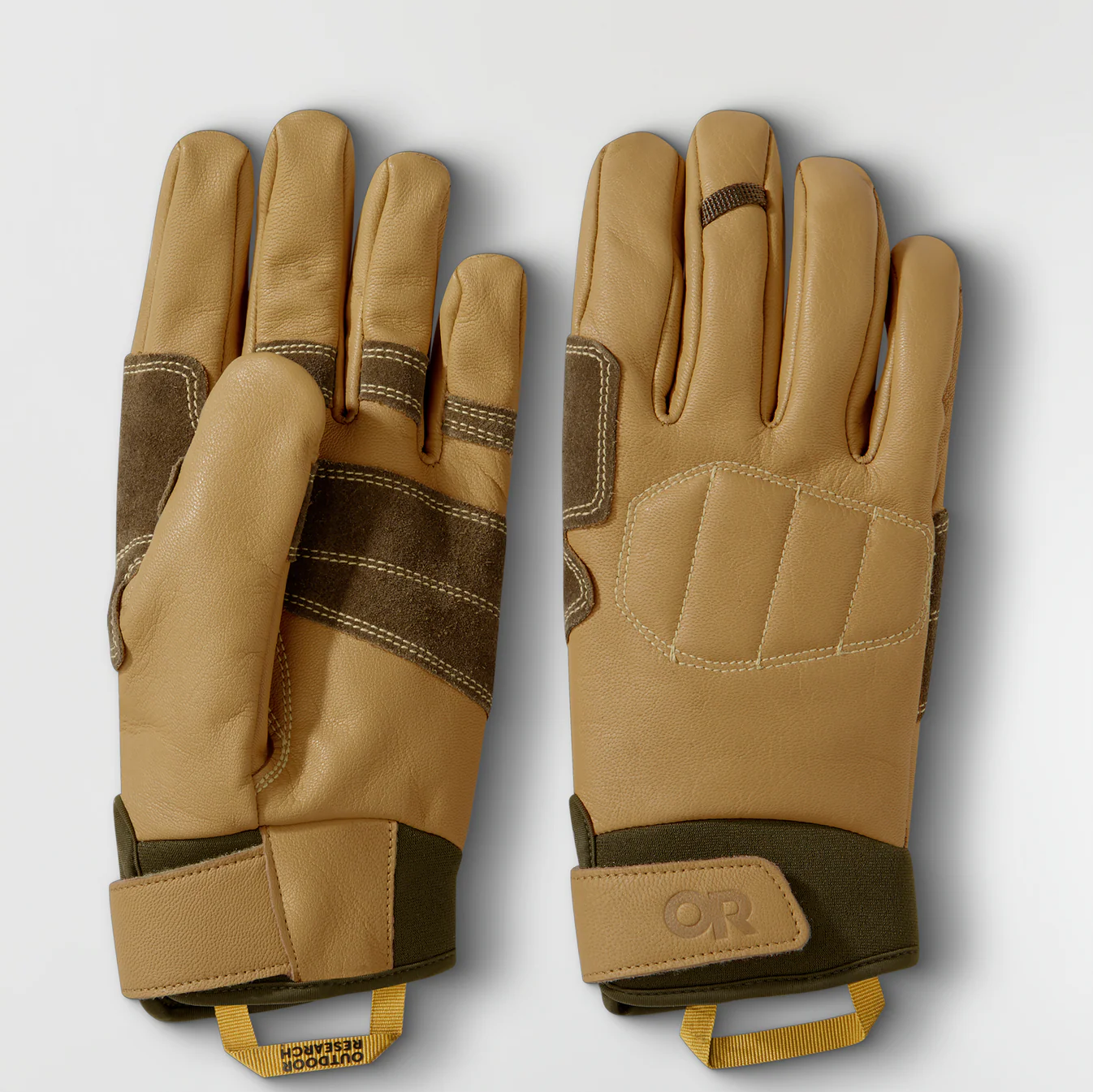 Pair of tan gloves with brown accents on a light gray background
