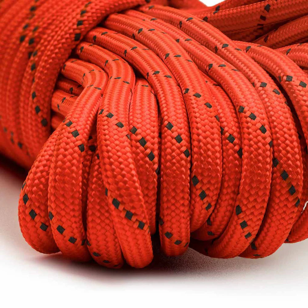 Coiled red rope with black dot pattern on a white background