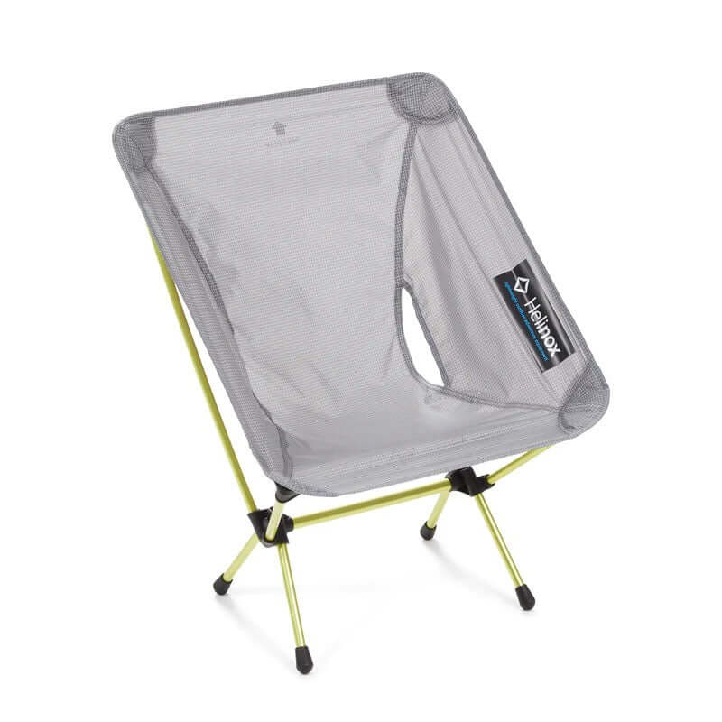 A Helinox Chair Zero, a lightweight portable camping chair, with blue frame and gray seat.