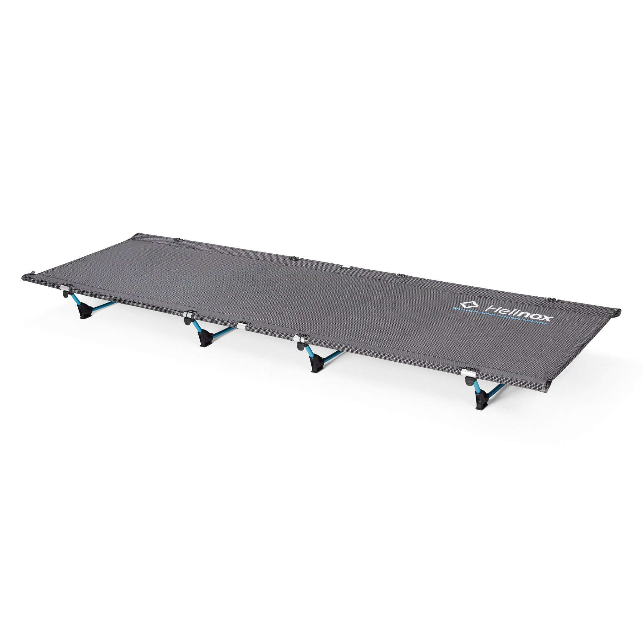 A black Helinox Lite Cot with blue DAC alloy frame, designed for ultralight hiking use.