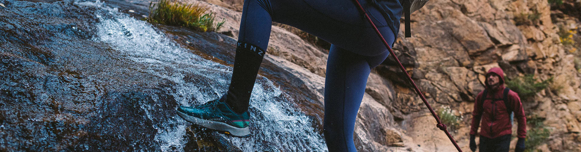 Someone canyoning off a waterfall in Sealskinz socks