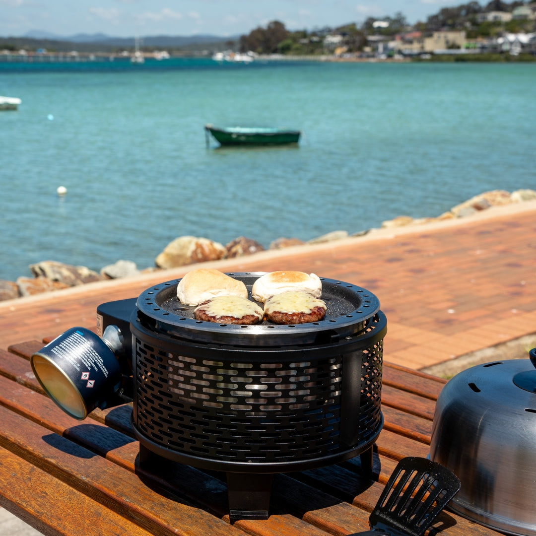 Cobb Grill Black cooking burgers by the water