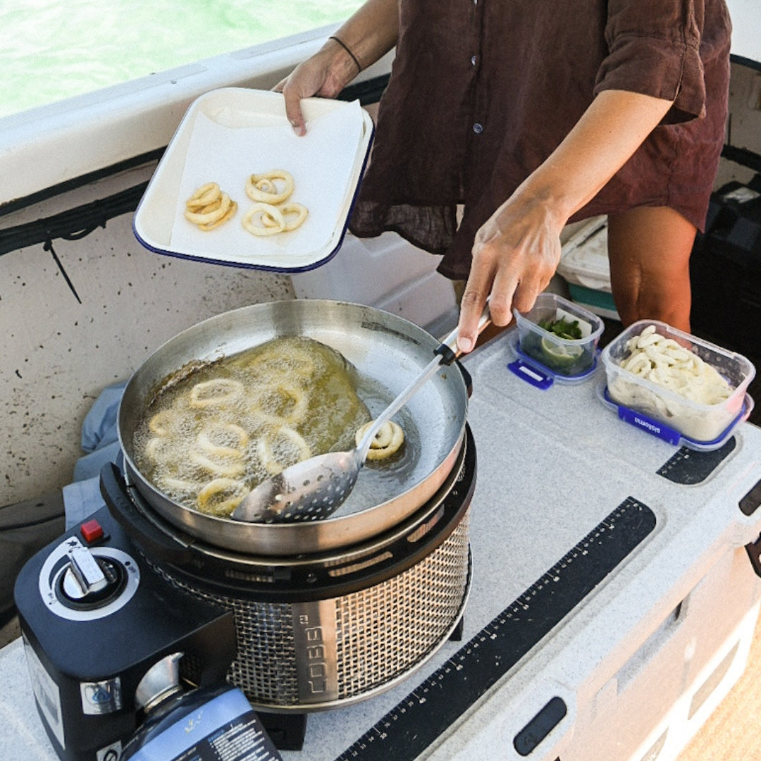 Cobb Grill deep frying squid on a boat
