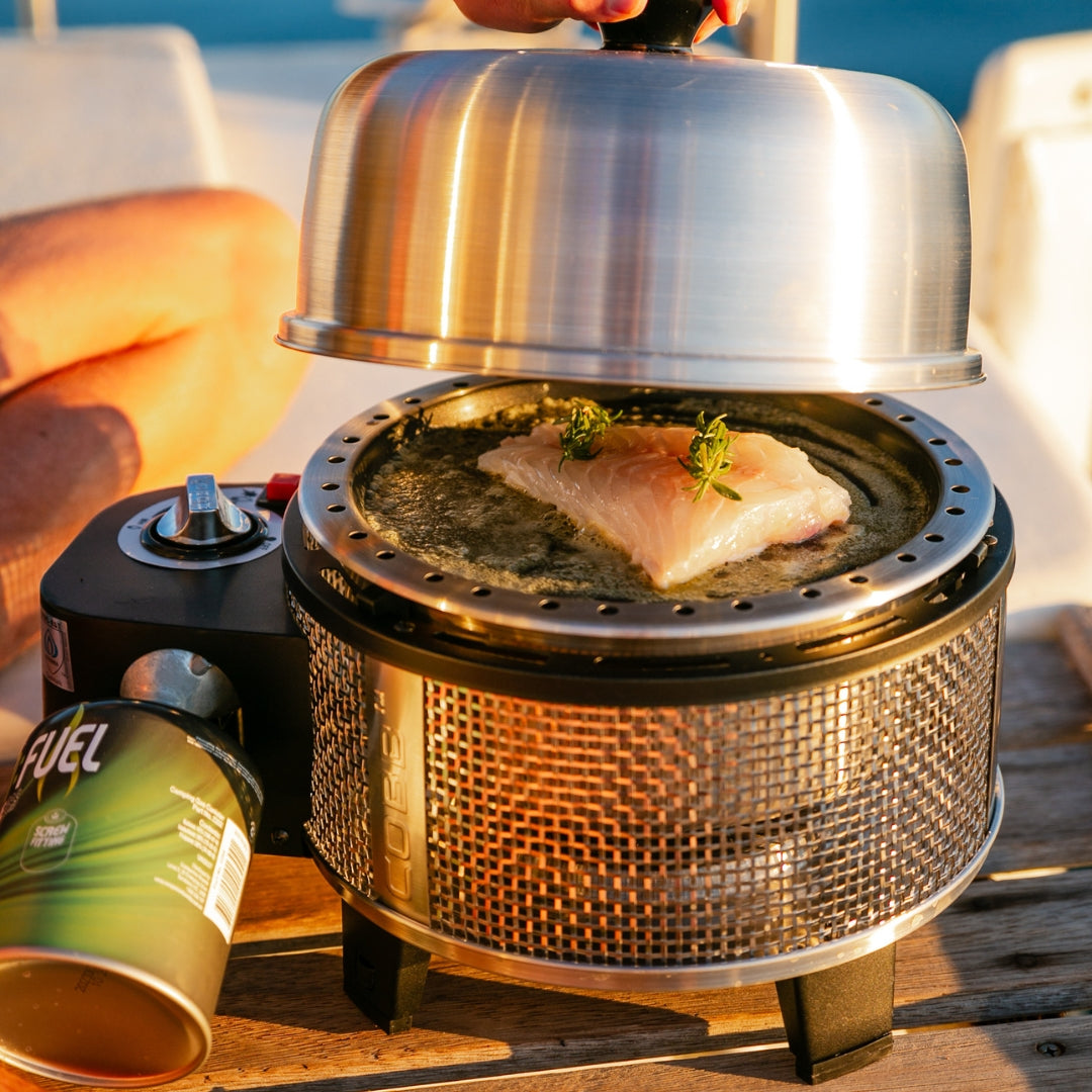 Cobb Frying pan cooking fish on a boat