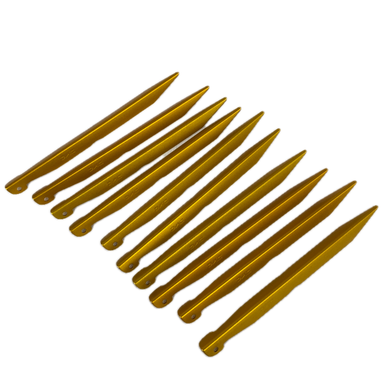 Gold-colored tent stakes on a white background