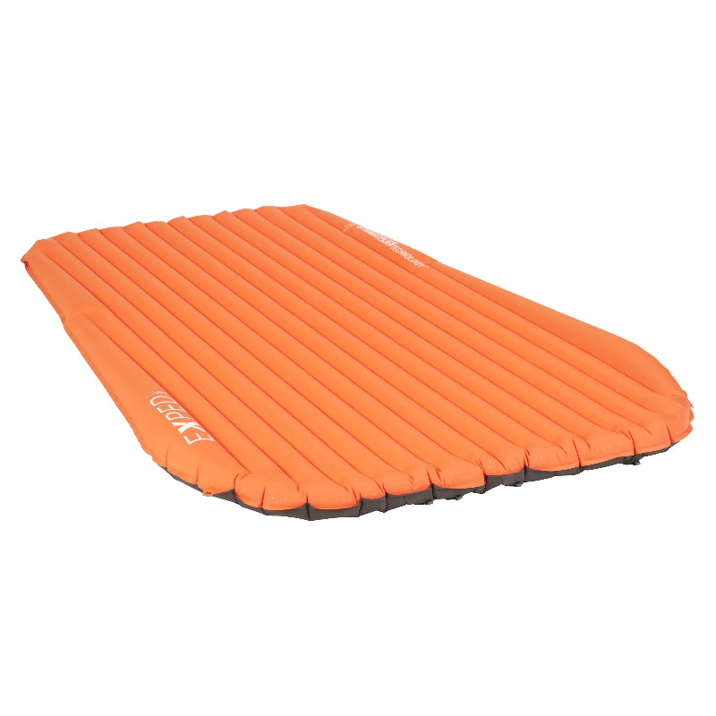 Orange inflatable camping mattress on a white background