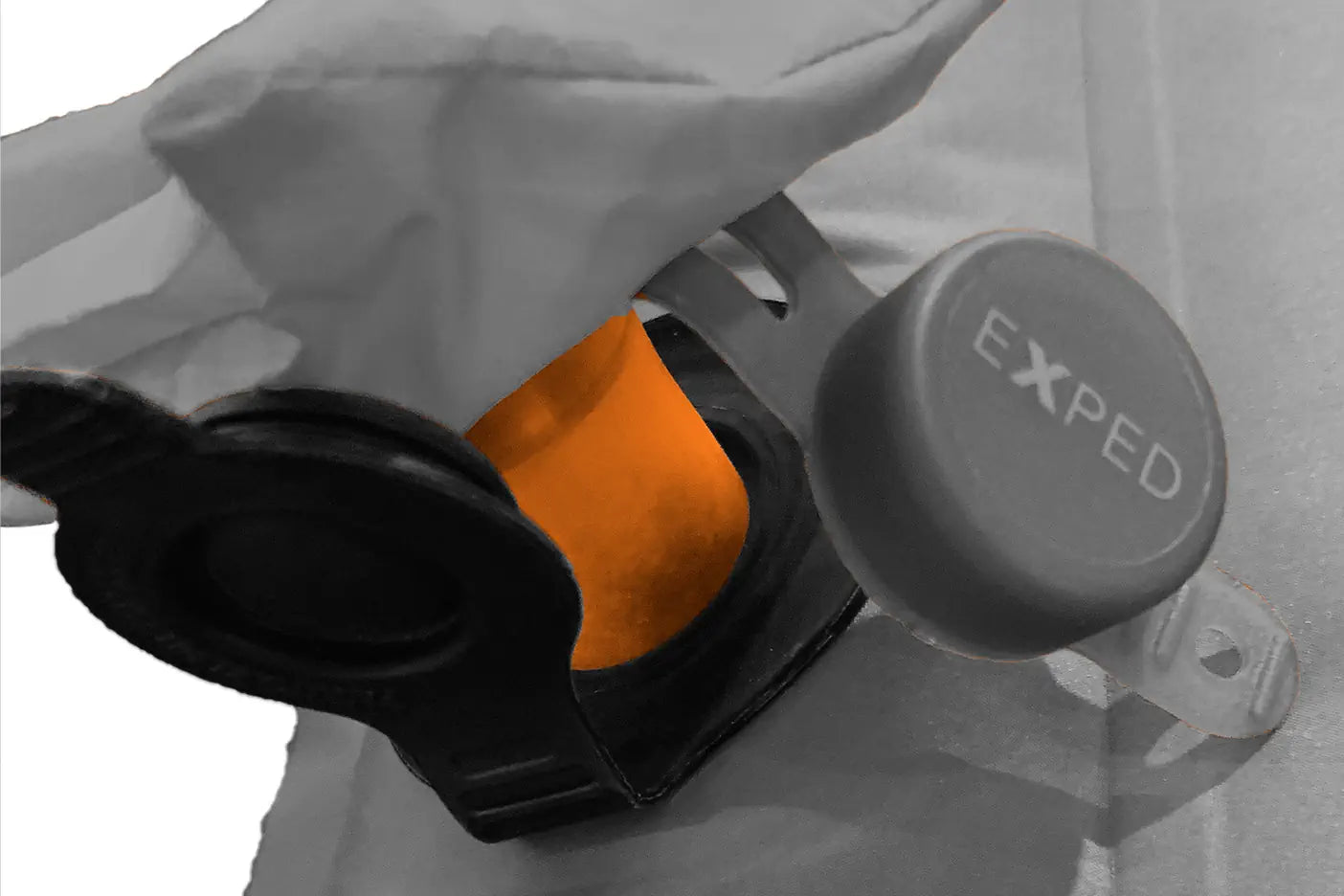 Close-up of the universal valve adaptor with Exped branding on a white background