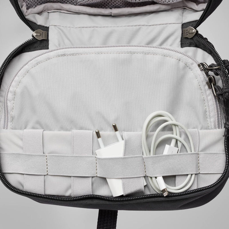 Gray backpack with electronic components inside on a light gray background