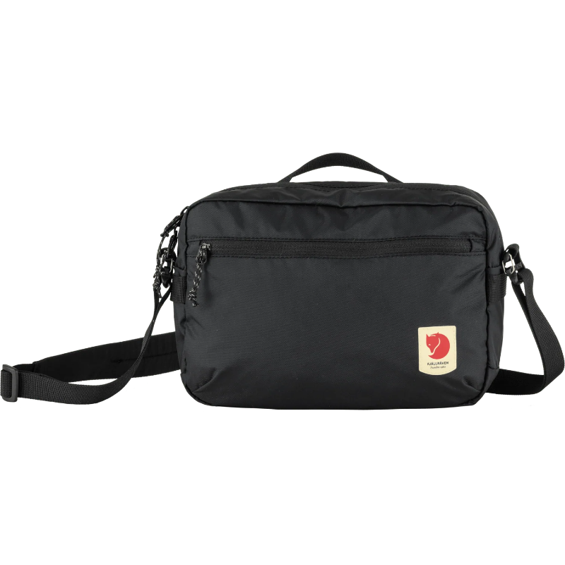 Black shoulder bag with a visible brand logo on a transparent background