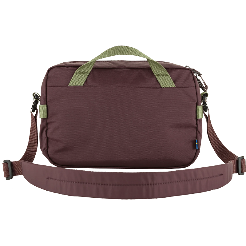 Brown bag with green straps on a white background