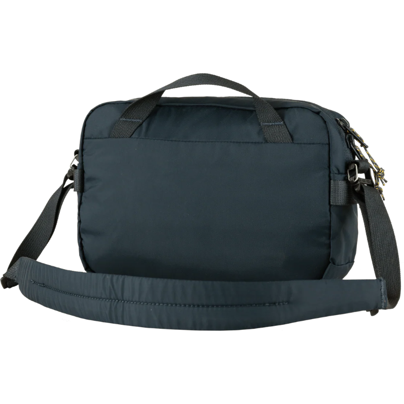 Navy blue bag with a shoulder strap on a white background