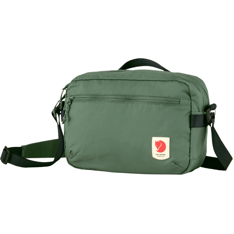 Green shoulder bag with a visible brand logo on a white background