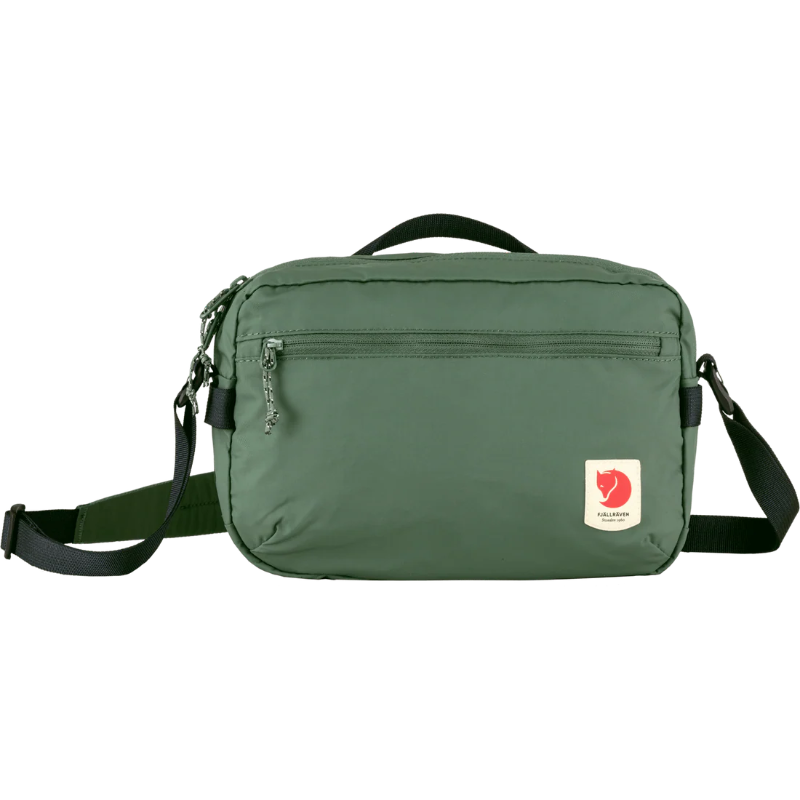 Green shoulder bag with a visible brand logo on a white background