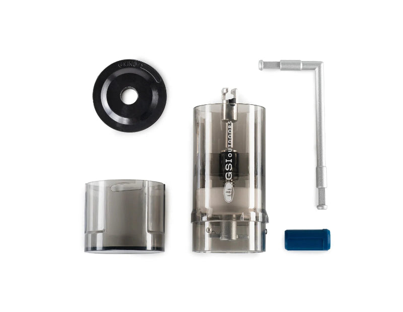 Coffee grinder with various parts on a white background