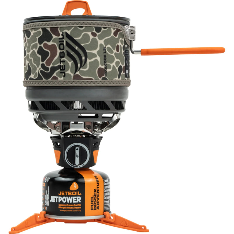 Camouflage camping stove with orange accents on a white background