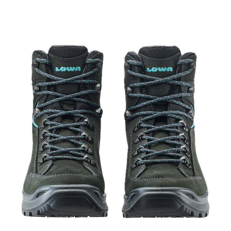 Pair of green hiking boots with black soles on a white background