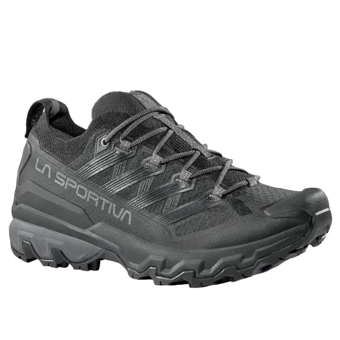 Black hiking shoe with brand logo on a light gray background