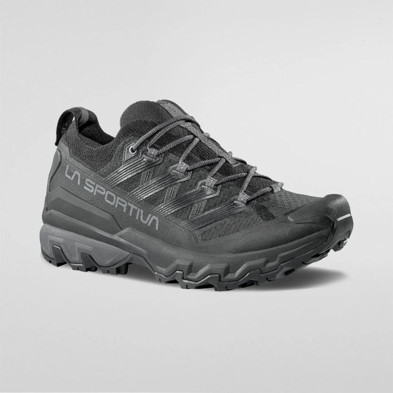 Black hiking shoe with brand logo on a light gray background