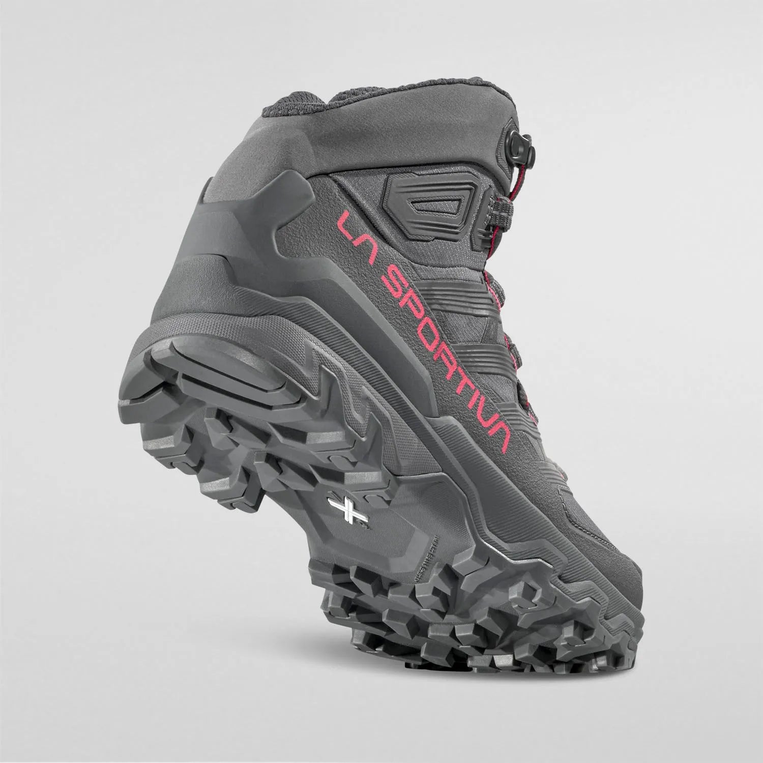 Gray La Sportiva Womens hiking boot with red branding on a light gray background