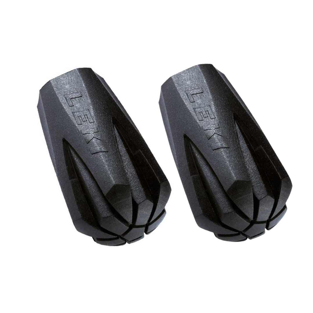 Two black Leki hiking pole tips on a white background