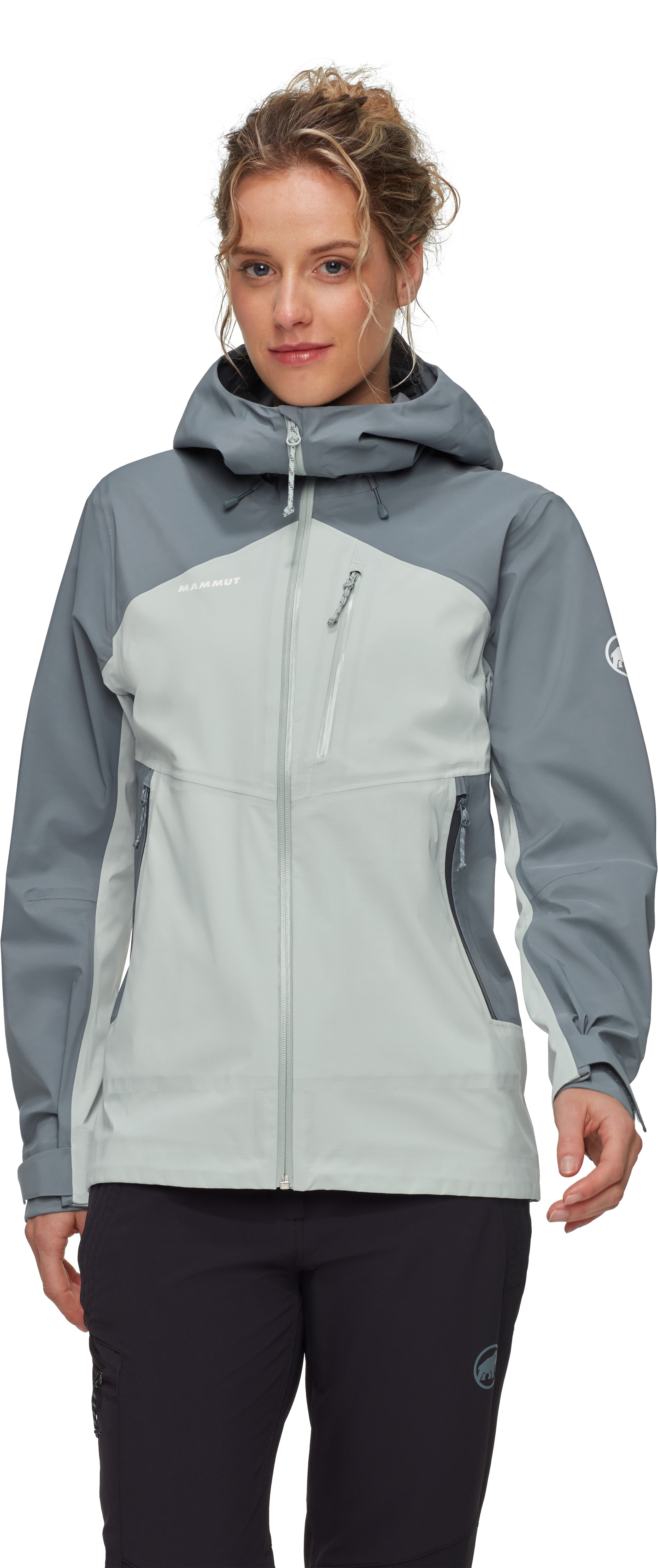 Woman wearing a gray and light blue jacket on a white background