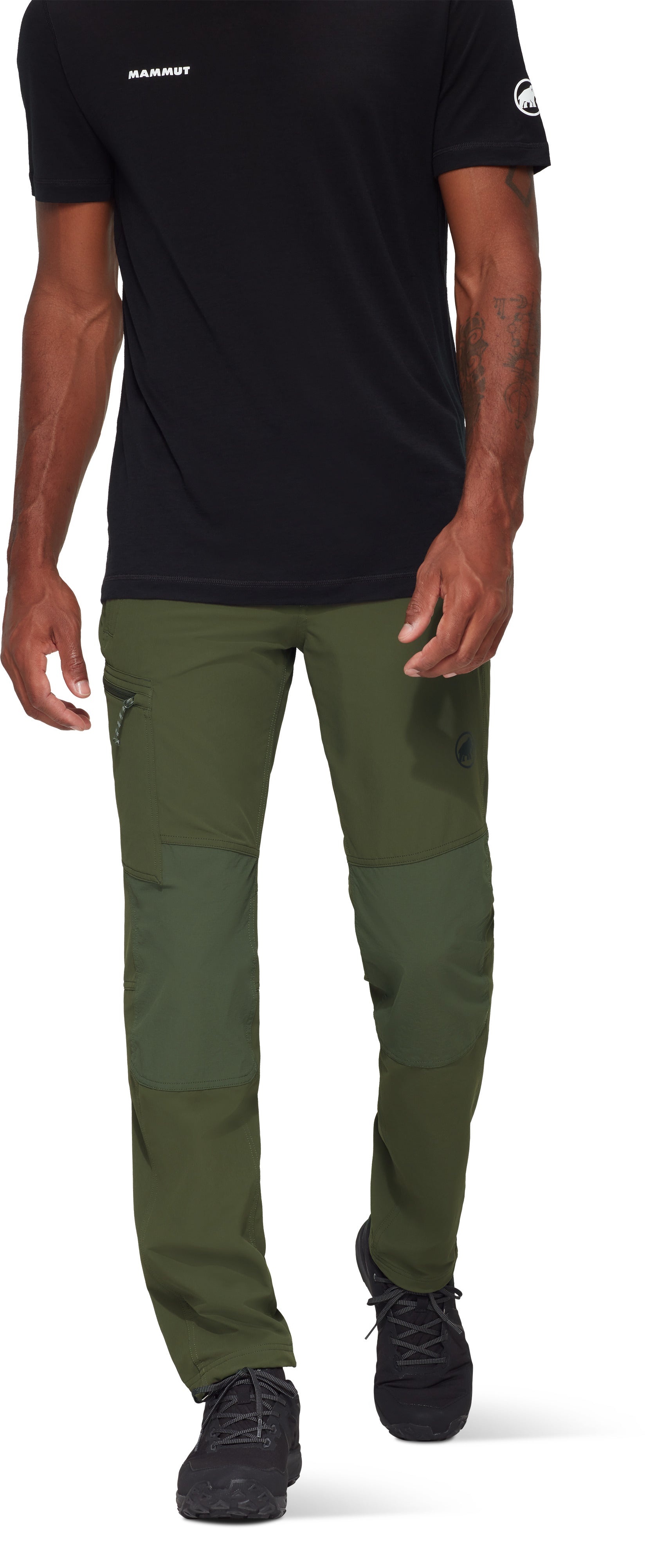 Person wearing a black t-shirt and green pants on a white background