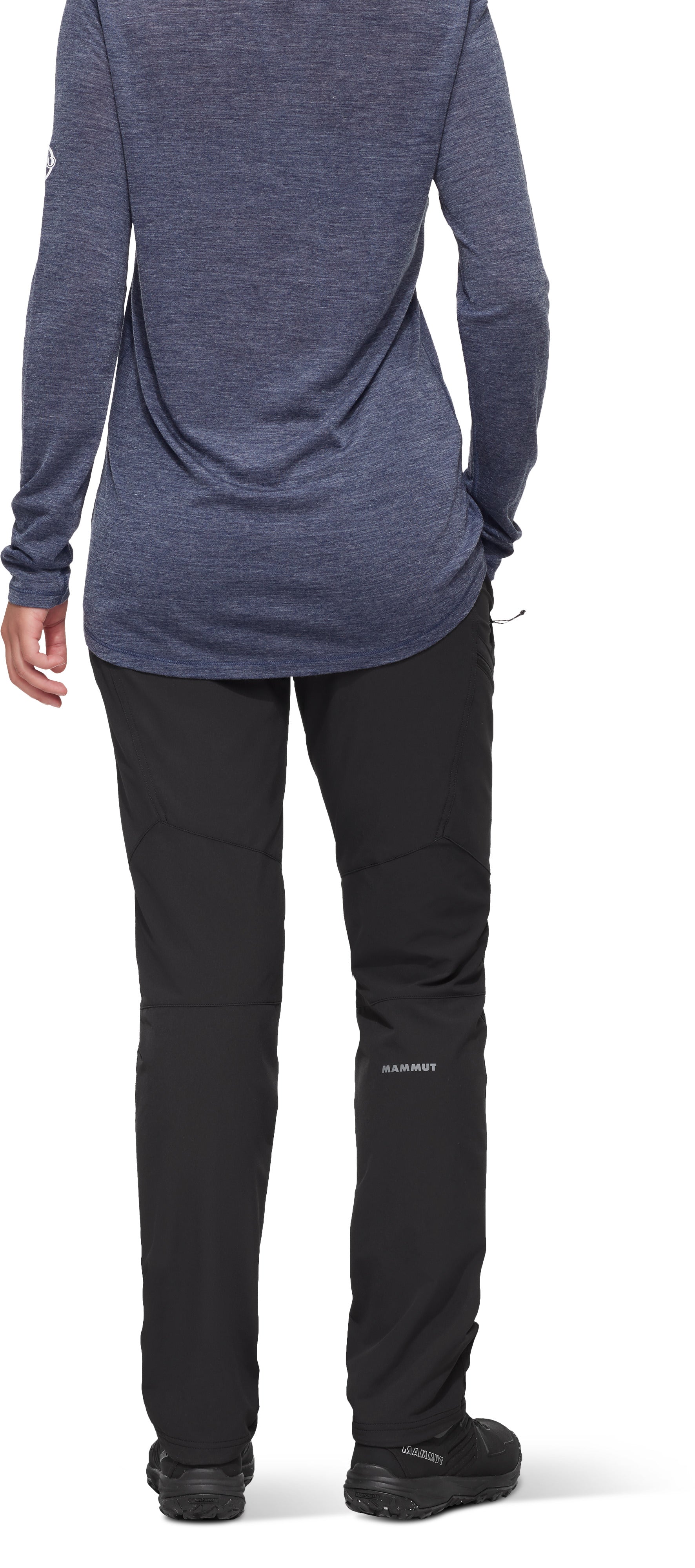 Person wearing a blue long-sleeve top and black pants on a white background