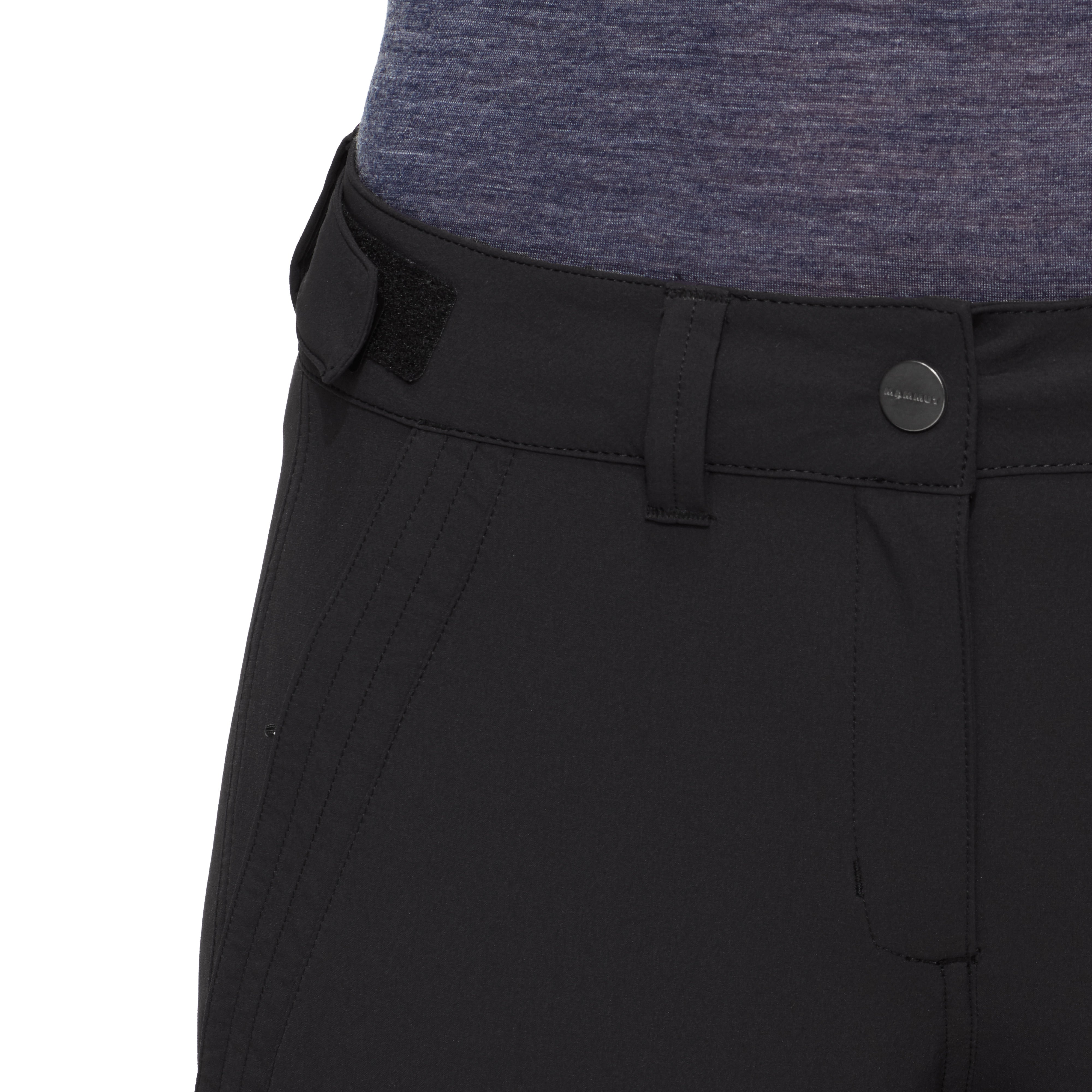 Close-up of black pants with a button and zipper on a white background