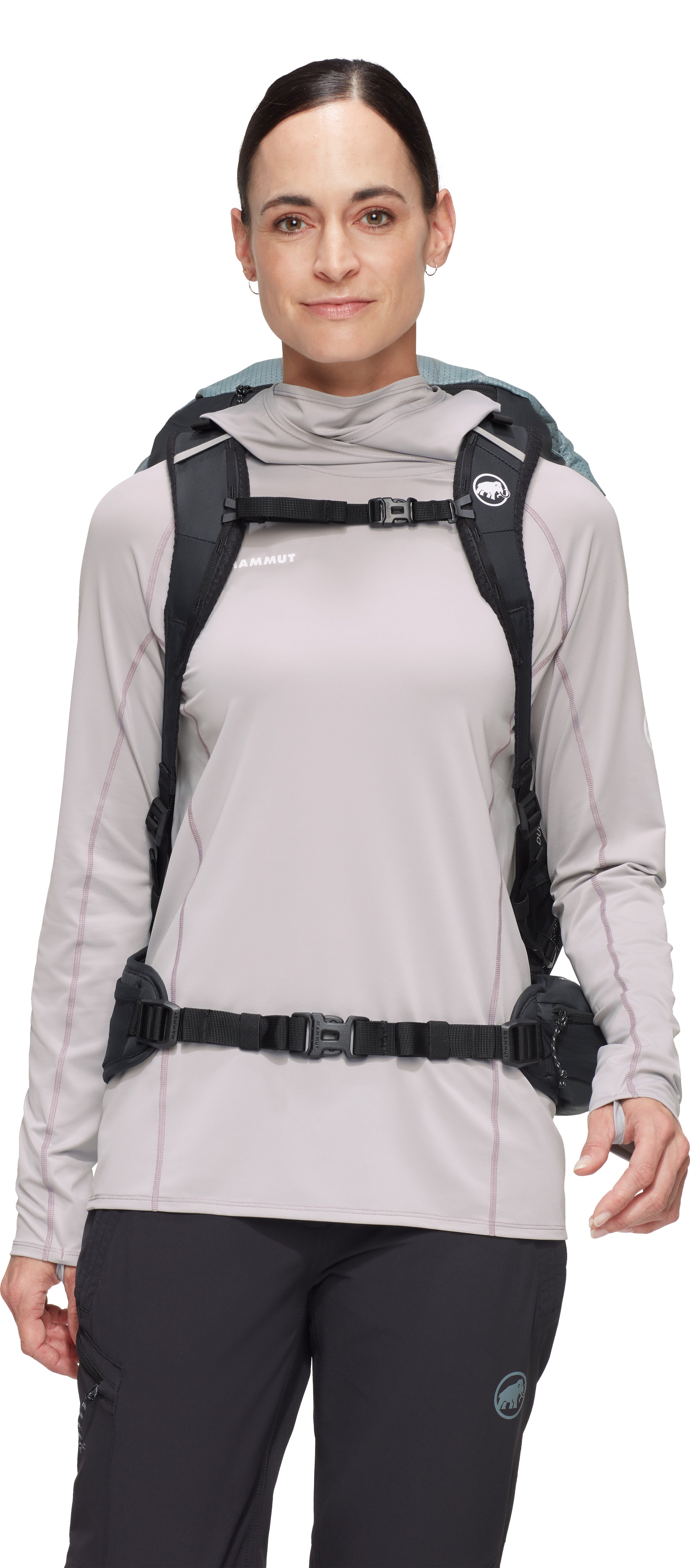 Woman wearing a light gray jacket with a black backpack on a white background
