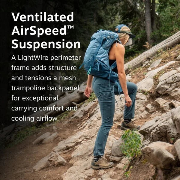 Person hiking on a rocky trail with a blue backpack, featuring text about Ventilated AirSpeed Suspension.