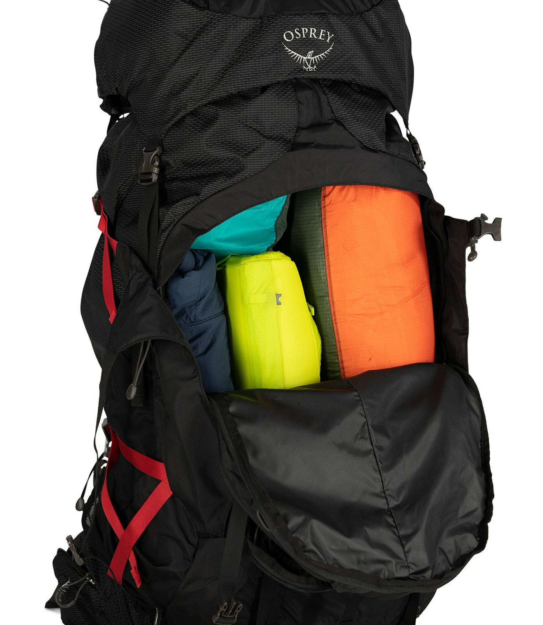 Black Osprey backpack with colorful items inside on a white background