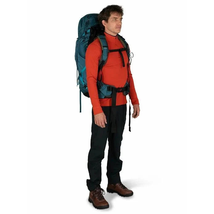 Man wearing a large blue backpack on a white background